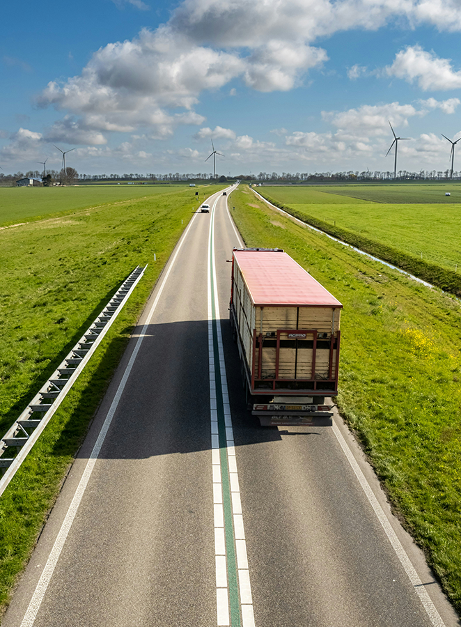 A truck driving on a road in the Netherlands. Photo: Sven Brandsma on Unsplash.