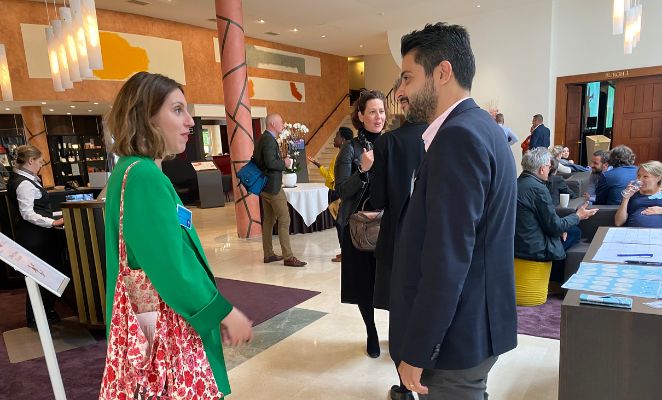 Two people in conversation at an event.