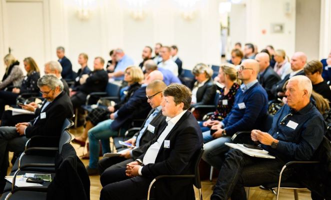 Rows of people seated, attending a seminar.