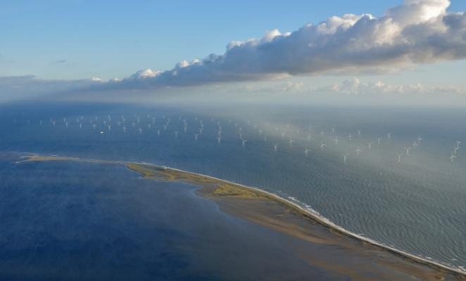 Coastal landscape with a windfarm and sunny weather.