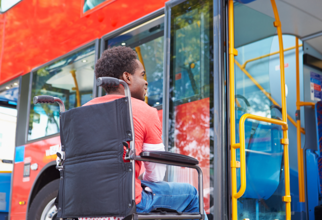 Person in wheelchair about to board the bus