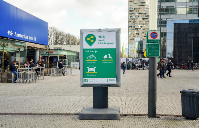 A hub board with the identity situated next to a train station