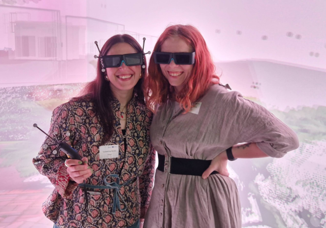 Two ladies wearing VR glasses with antennae