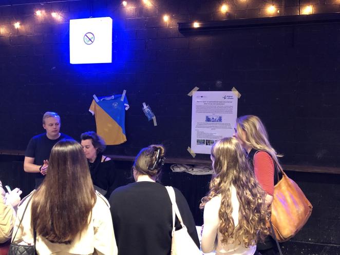 Photo of young people talking at event