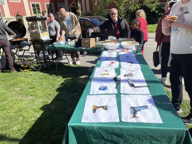 Photo of residents taking part in Barbeque and exploring sharing station items