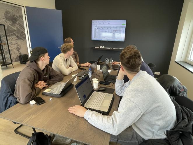 students working on laptops in a group