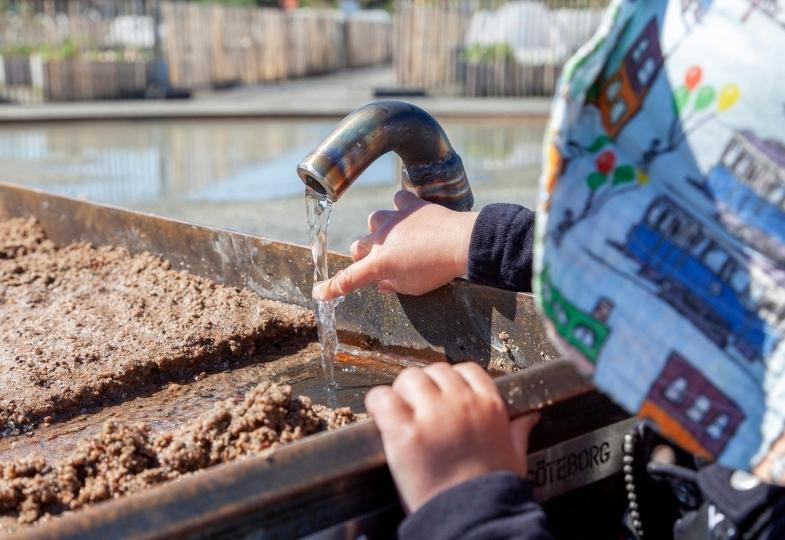 Child playing with water.