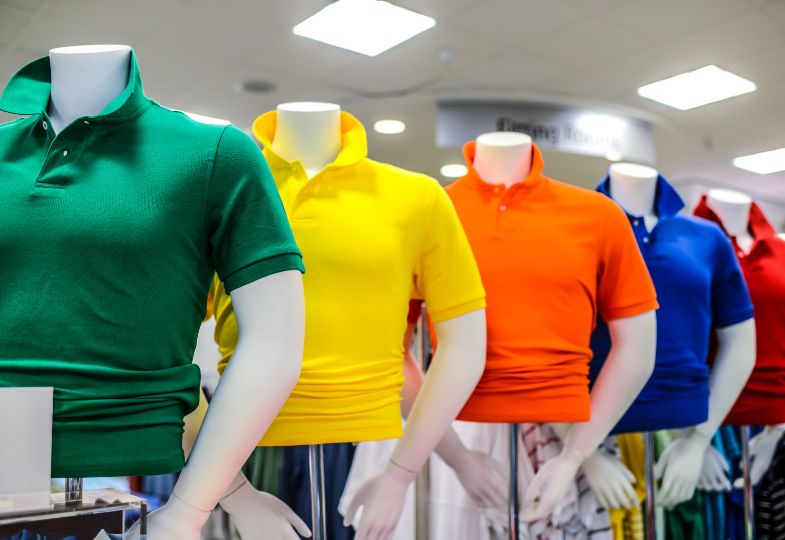Colourful polo shirts on mannequins in a shop