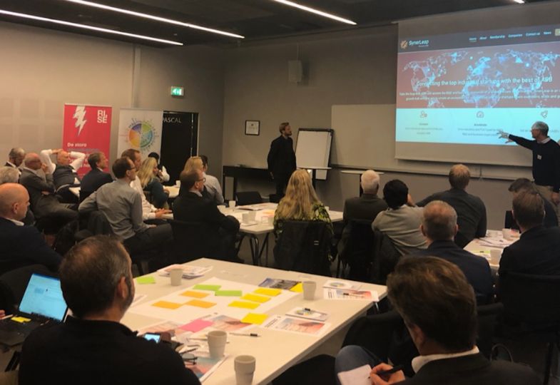 People from small and medium sized companies in a large room attending a training