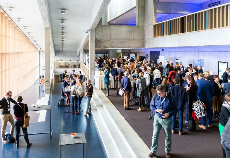 Many people gathering in the lobby during a conference