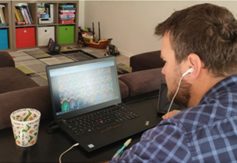 Peter Racz working online at the computer from home
