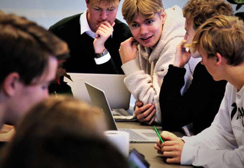 School boys working in a group at laptops