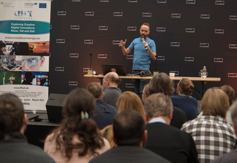 Speaker in front of an audience at Hamburg Film Festival