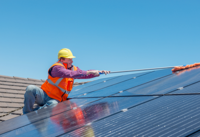 Man cleaning solar panels