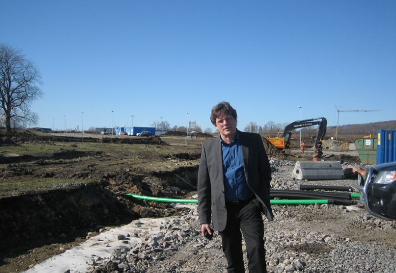 Dirk Harmsen wearing a business suit at a construction site.