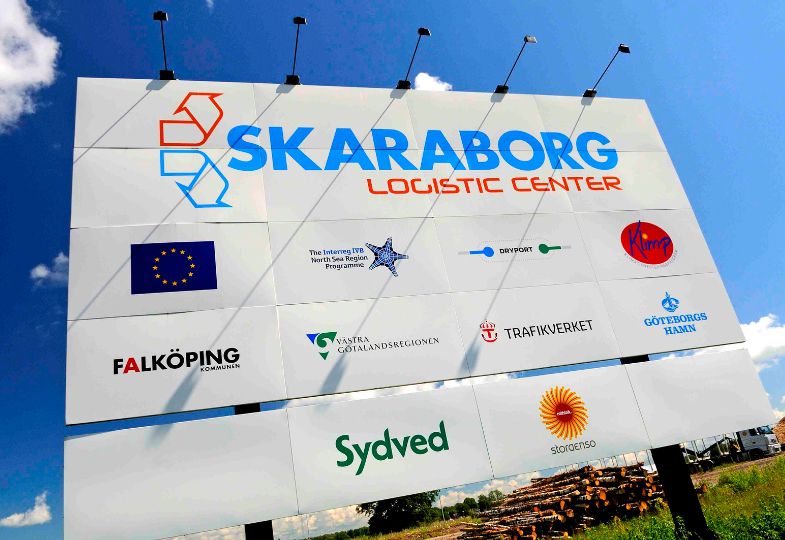 Big billboard signposting the Skaraborg Logistics Centre, including a large EU flag. 