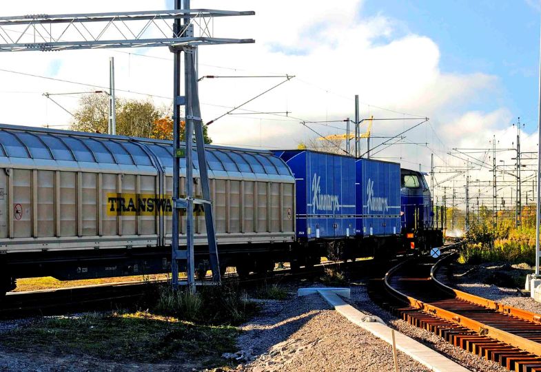 A cargo train passing through a landscape.