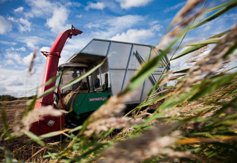 A harvester moving fast through the crops.