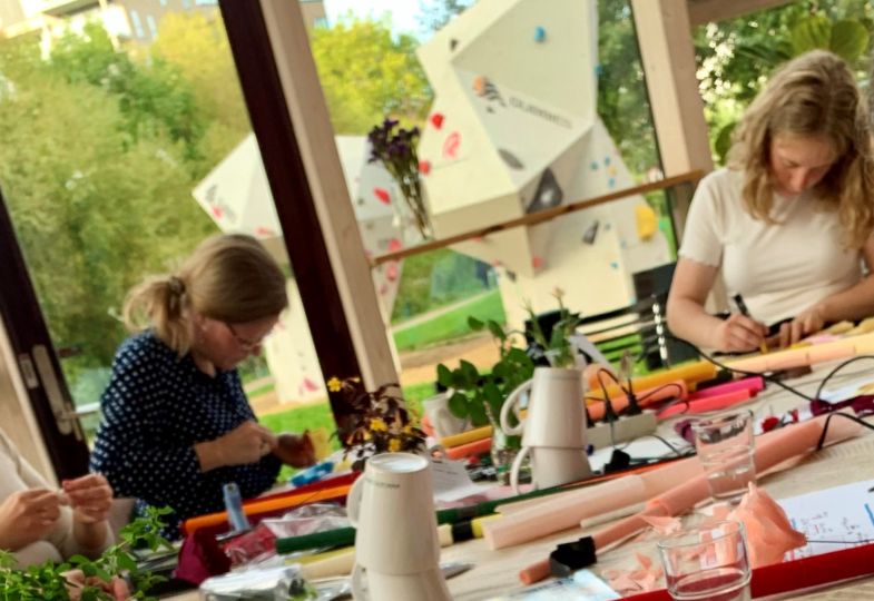 Two young ladies busy with handicraft at a DIY workshop.