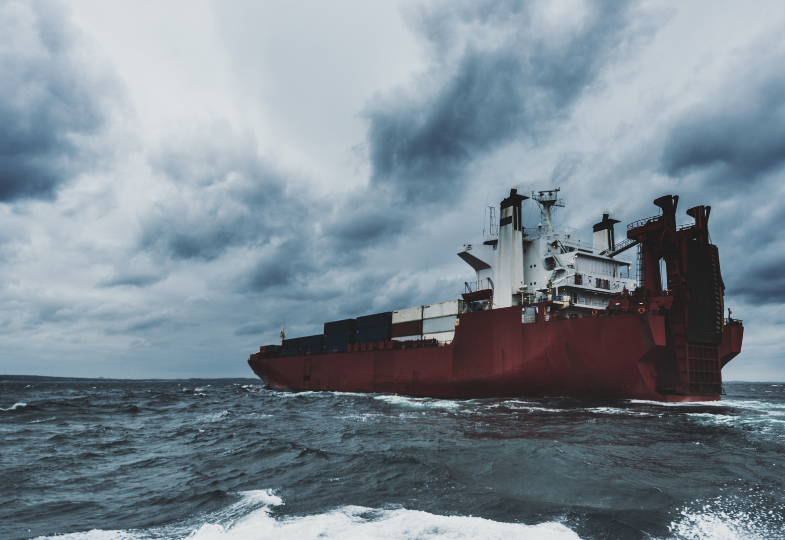 A container ship sailing across an unruly sea.