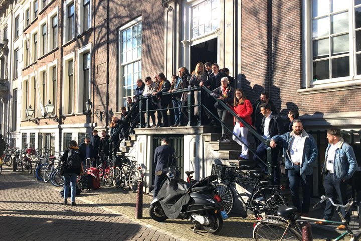 A group of people standing on a staircase in front of a house.