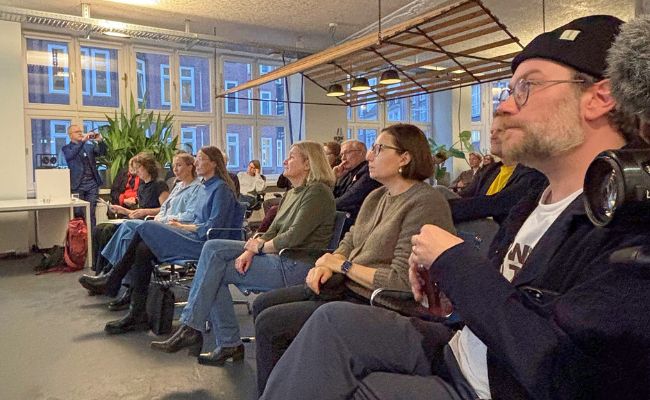 An attentive audience seated at a meeting.