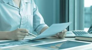 Woman holding a document.