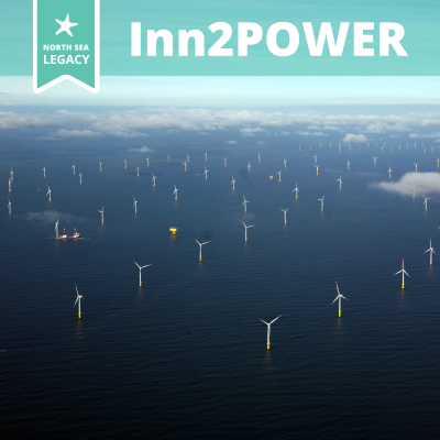 A blue North Sea seen from above in lightly clouded weather, dotted with wind turbines and a yellow test facility.