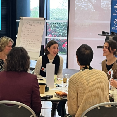 People in conversation around a table. 