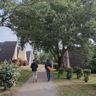 people walking between houses