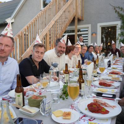 All partners dine together at a traditional Swedish lobster party.