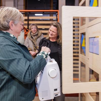 Photo of resident borrowing a sewing machine from the sharing station