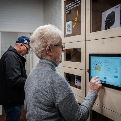 Photo of senior citizen using sharing station