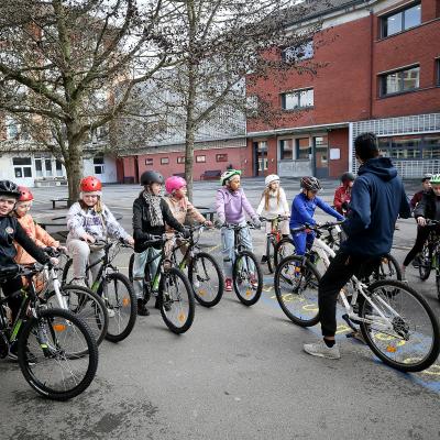A group of children riding bikes.