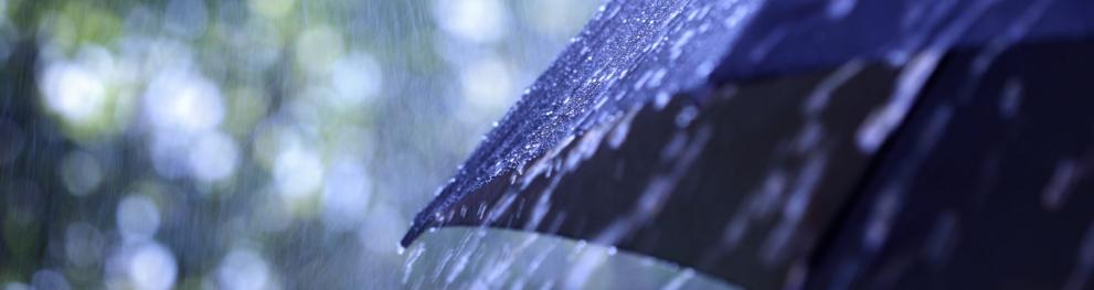 A blue umbrella in rainy weather