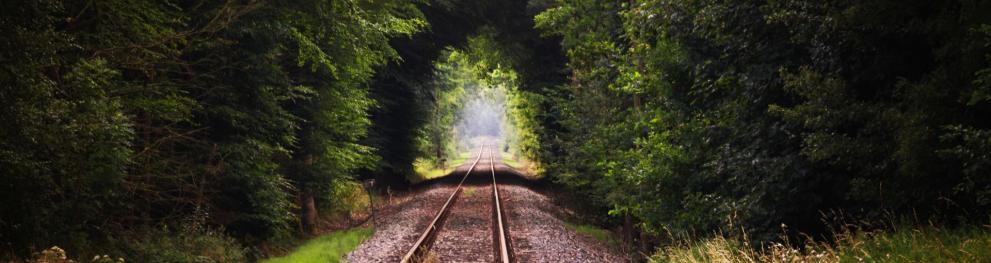 Railway tracks leading towards light