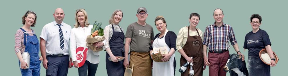 A group of smiling people holding food products in their hands.