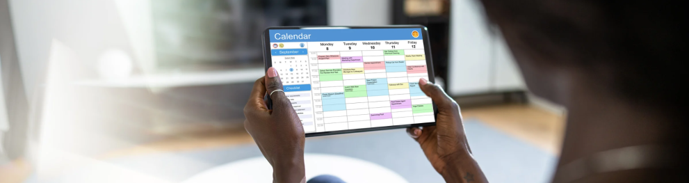Person holding a tablet with a calendar