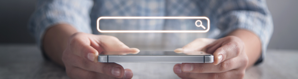 close-up of hands holding a mobile phone, with an icon showing the person is searching on the web