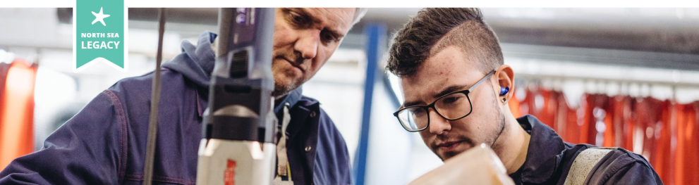 Two workers focused on a manufacturing task.