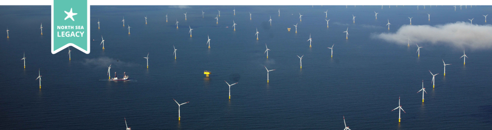 Aerial photo of a blue North Sea dotted with wind turbines, and with a yellow test facility.