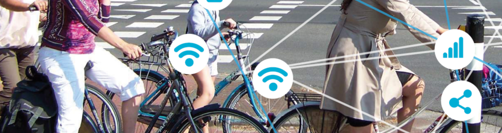 People on bicycles waiting at traffic light