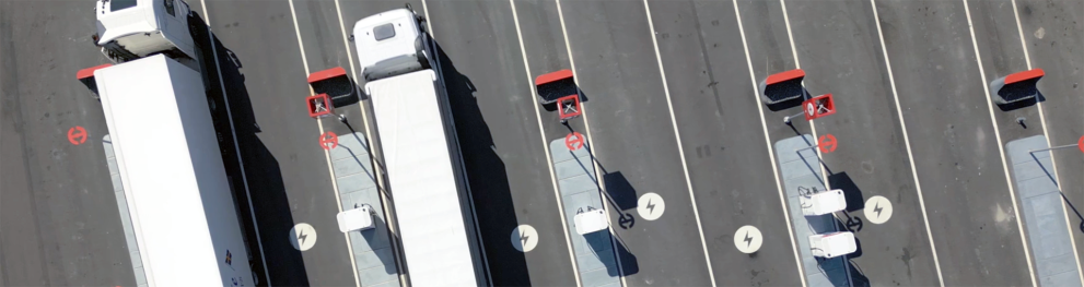 Aerial view of trucks charging at a truck stop.