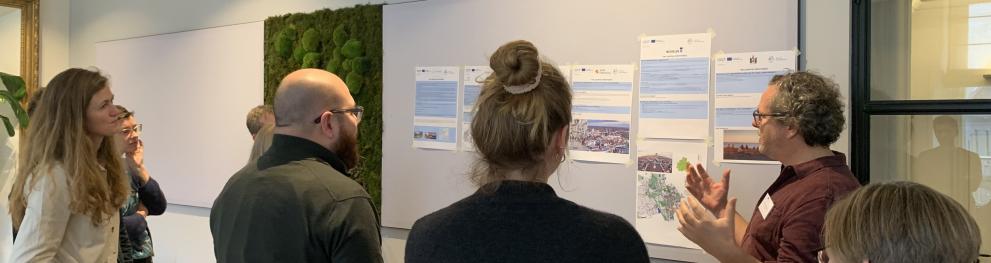 A photo from the Kickoff meeting of the Speak Up project, where one of the partners is presenting about their city and plans for the project.