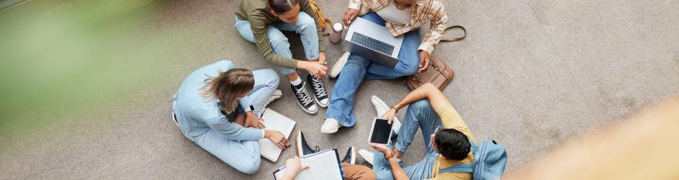 Group of young people sitting in a circle studying