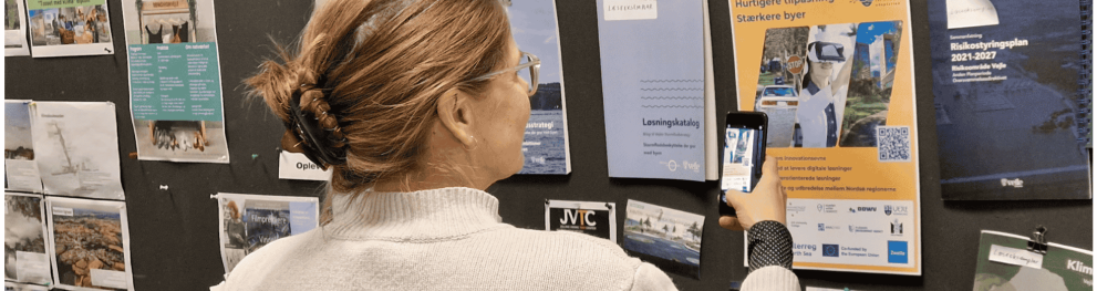 An interested passer by scans the qr-code on the new DISCO poster at Vejle Municipality, Denmark 