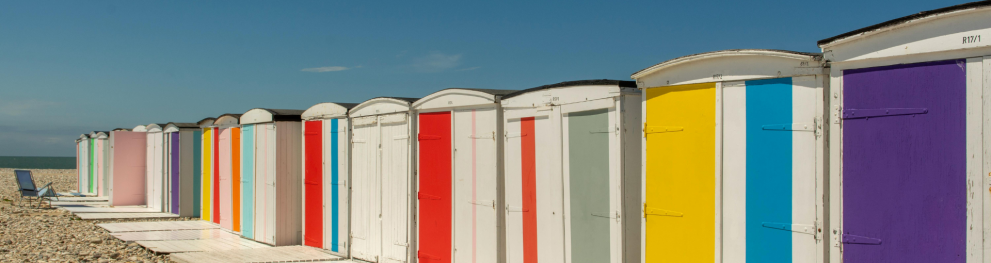 Beachhuts lined up leading to the sea