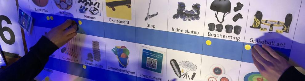 Photo of sharing station options with young people pointing at them