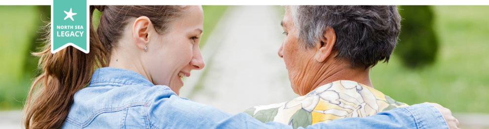 a young lady with her arm around an elderly lady.