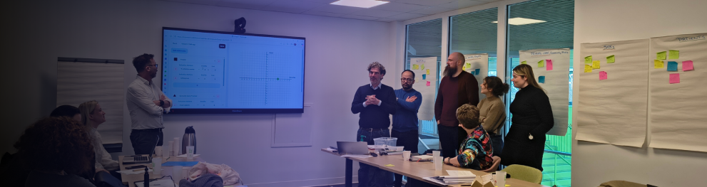 Photo of partners presenting in Lille with blue gradient effect on top of photo